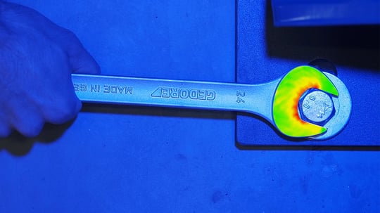 ARAMIS measurement of an aluminum wrench under load, with the FEA prediction and the measurement-vs-simulation deviation map shown side by side for direct correlation ARAMIS measurement of an aluminum wrench under load, with the FEA prediction and the measurement-vs-simulation deviation map shown side by side for direct correlation
