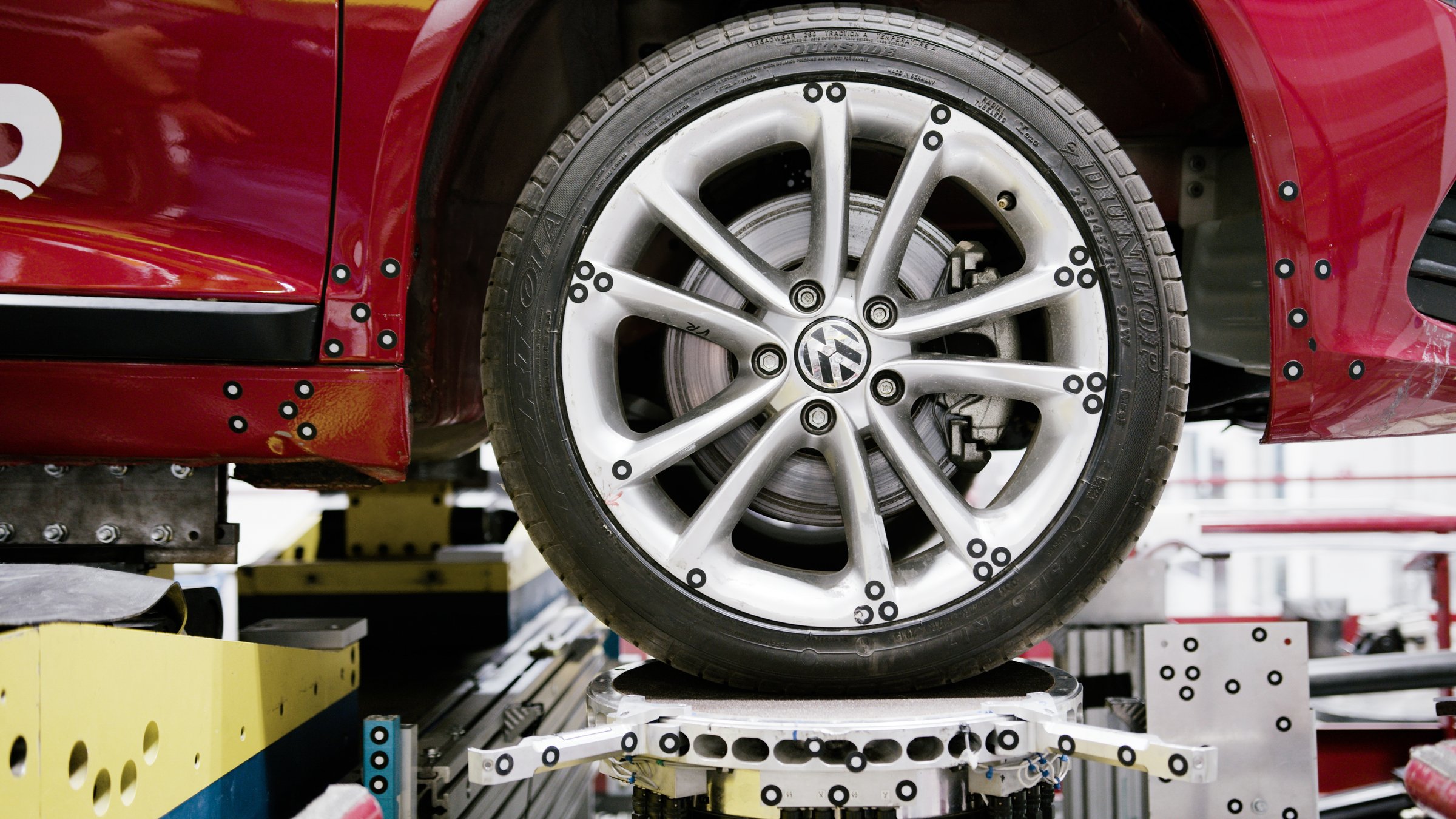 Photogrammetry targets applied to a VW wheel and suspension rig during a measurement campaign.