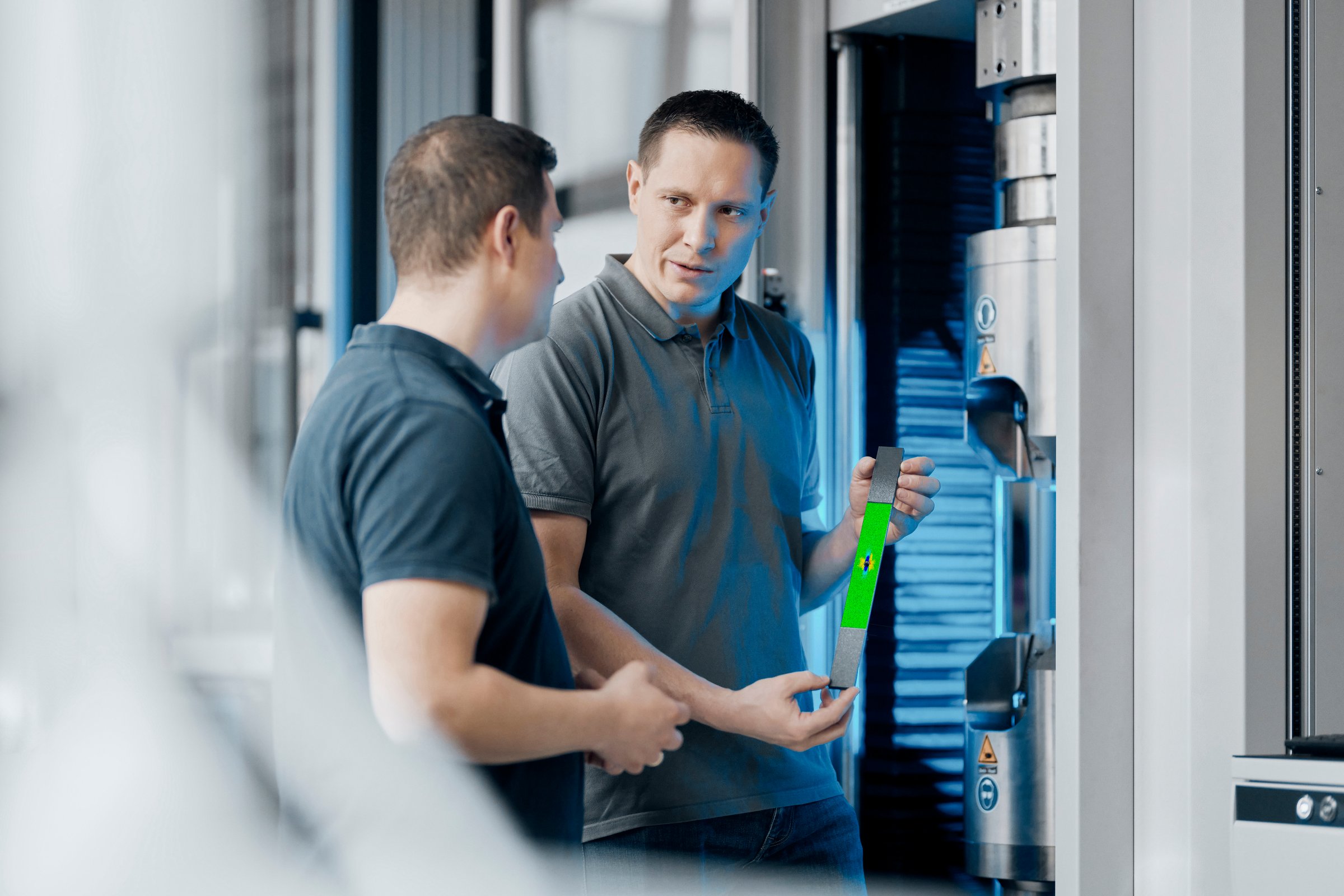 Trilion engineer walking a customer team through ARAMIS strain results shoulder-to-shoulder